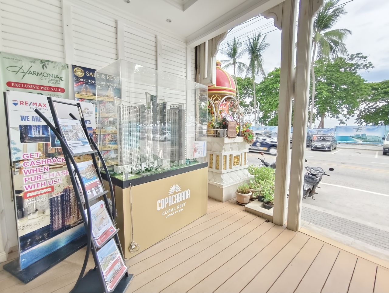 Property brochures and project model display outside the RE/MAX By The Sea office