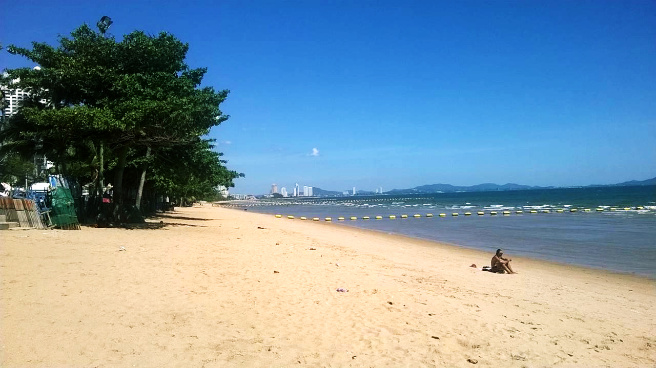 Jomtien Beach Pattaya — golden sand beach with Pattaya skyline in the distance