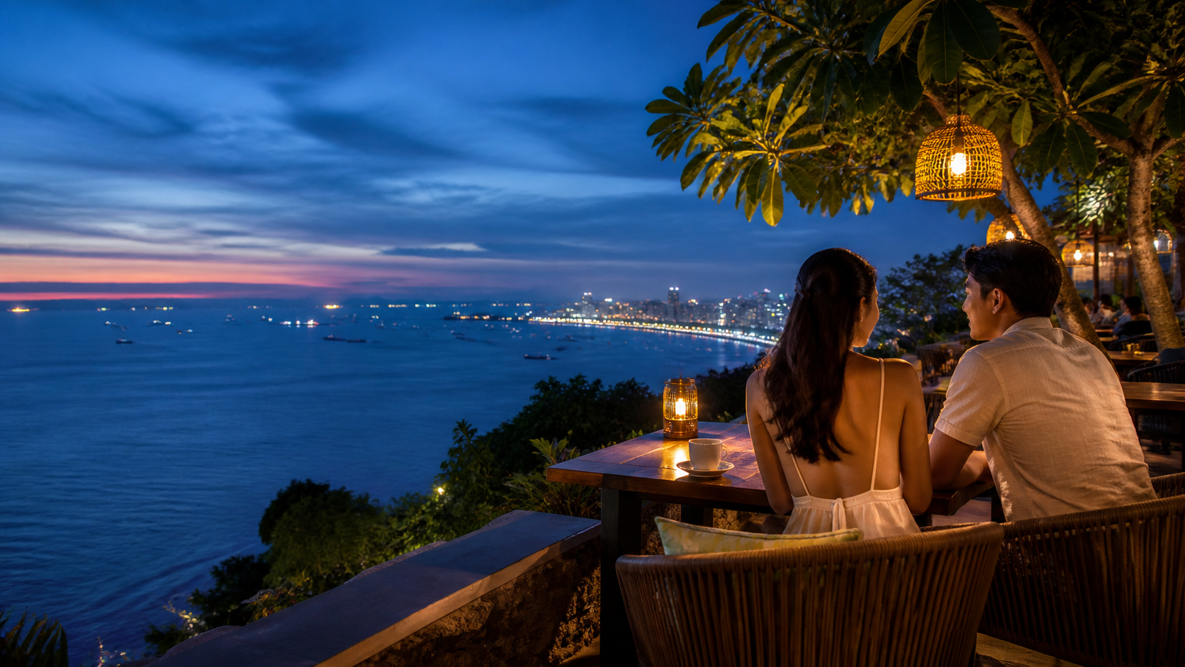 Cliffside ocean-view café overlooking Pattaya Bay at twilight